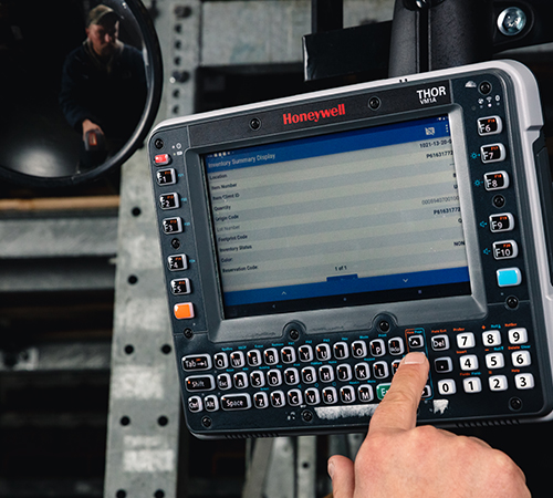 A man interacting with the Honeywell Thor VM1A Vehicle-Mounted Computer.